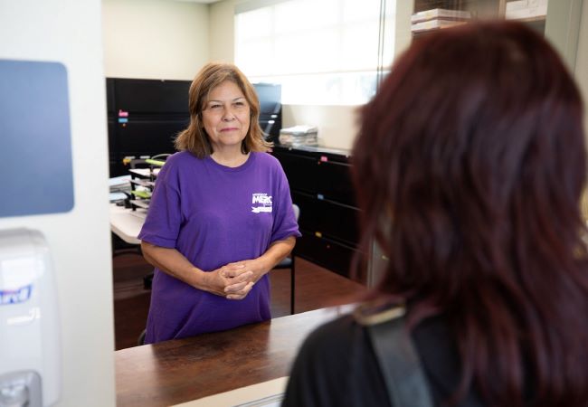 Mission of Mercy employee helping customer