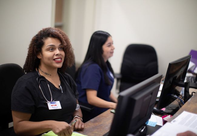 Mission of Mercy employee smiling at patient