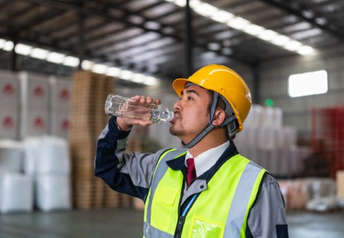 Employee staying healthy on the job by drinking water