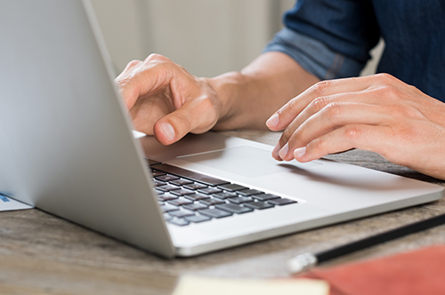 Hands working on laptop