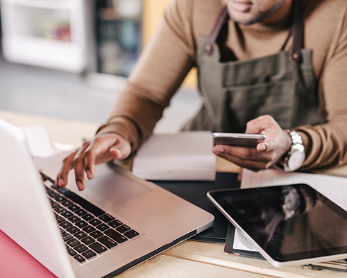 Policyholder calculating finances on a laptop