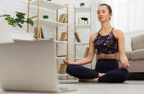 woman learning yoga online