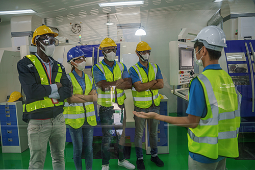 Factory workers and technician wearing face mask