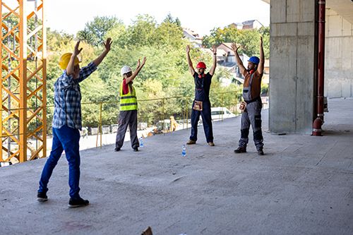 Construction workers stretching