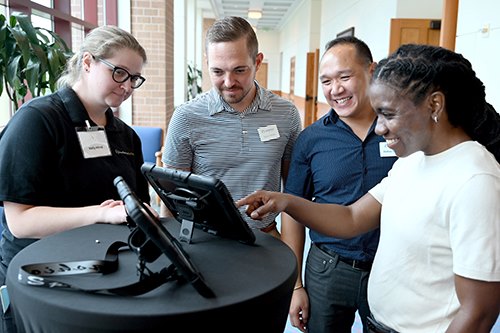 Team members looking at tablet screen