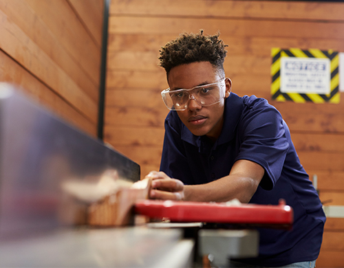 teen worker at meat slicer